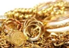 Gold slips from two-week peak as dollar ticks up Gold